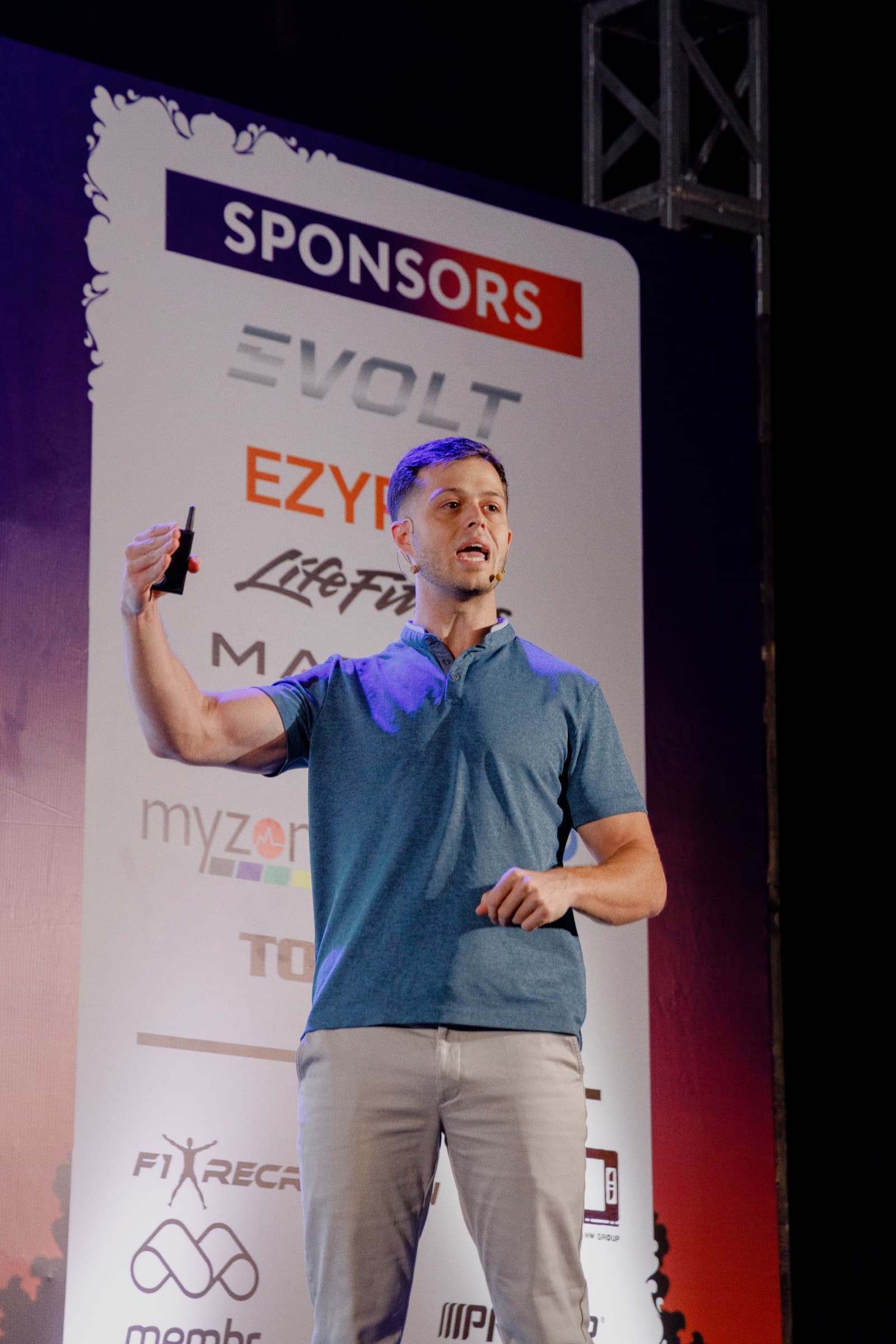 Jordan speaking on stage at conference with clicker in hand